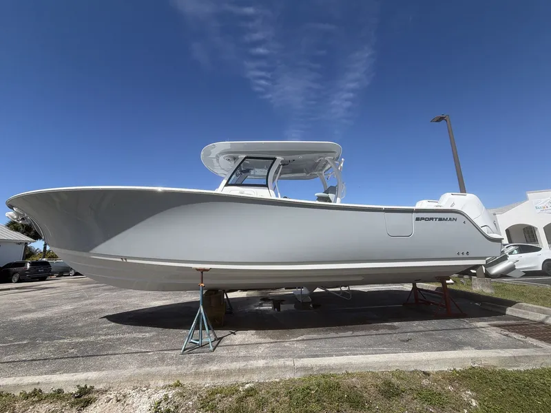 Slide: The Image of 2026 Sportsman Open 322 Center Console boat on a parking lot. - 4