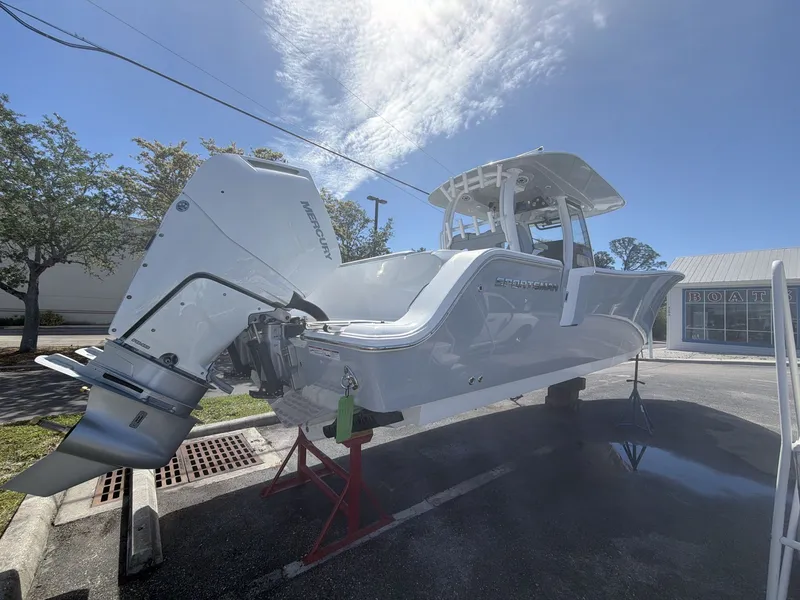 Slide: The Image of 2026 Sportsman Open 322 Center Console boat displayed in parking lot. - 7