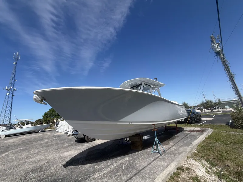 Slide: The Image of 2026 Sportsman Open 322 Center Console boat on a parking lot. - 9