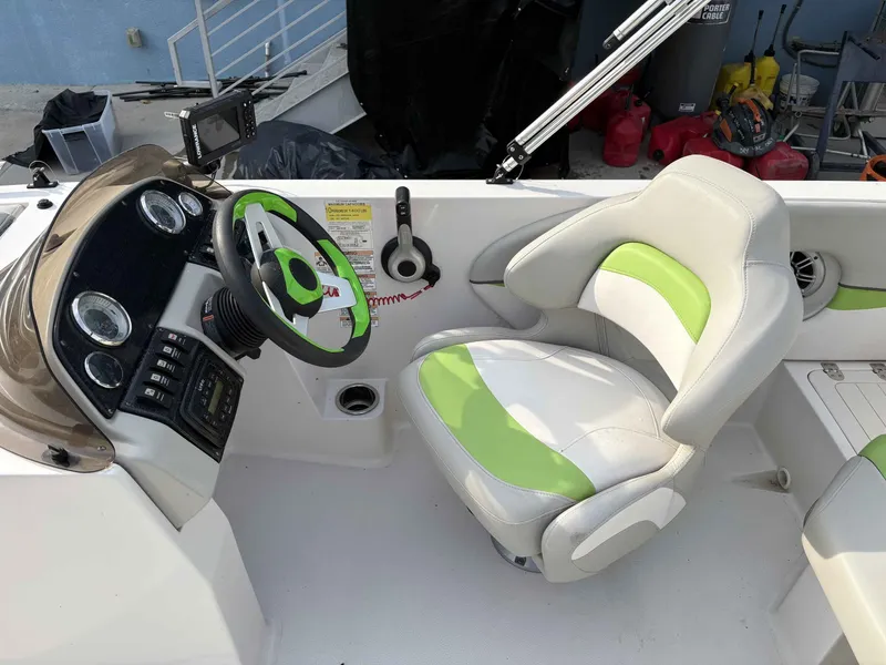 Slide: The Image of Interior of a 2017 Starcraft MDX 191 boat with green steering wheel. - 13