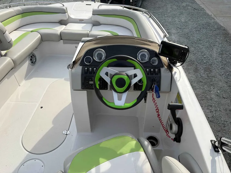 Slide: The Image of Interior of a 2017 Starcraft MDX 191 boat with green steering wheel. - 14