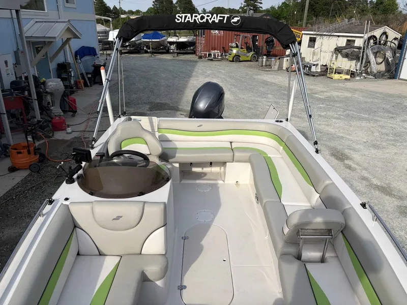 Slide: The Image of Interior view of a 2017 Starcraft MDX 191 boat with green and white seating. - 4