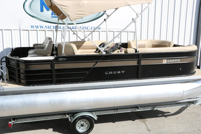 Slide: The Image of 2020 Crest Classic Fish 200 pontoon boat with beige seating and canopy. - 11