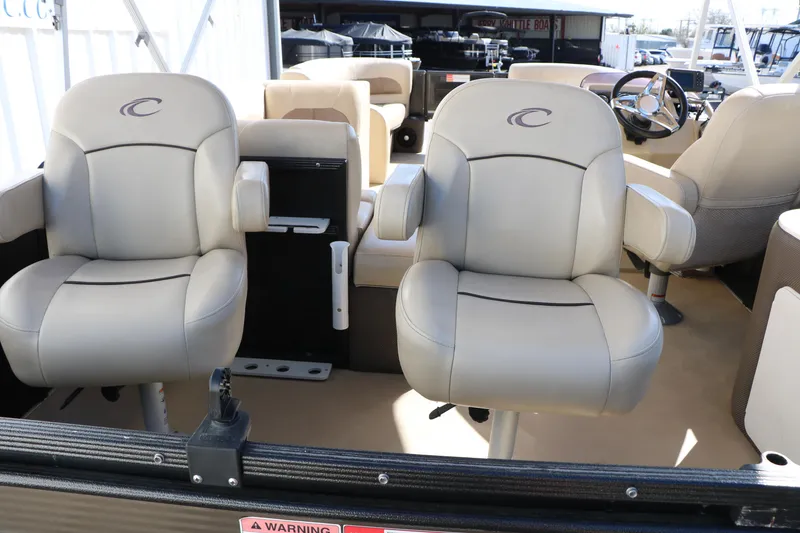 Slide: The Image of 2020 Crest Classic Fish 200 boat interior with beige captain chairs. - 17