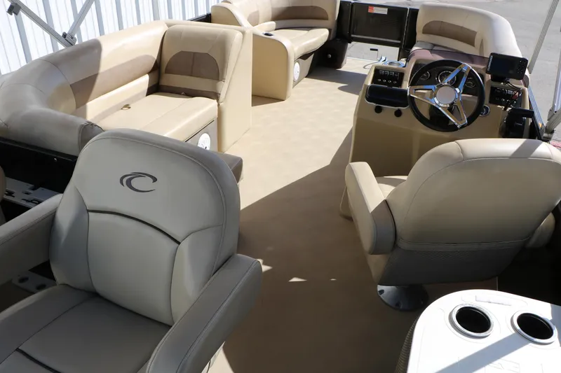 Slide: The Image of Interior of a 2020 Crest Classic Fish 200 pontoon boat with beige seating and steering console. - 21