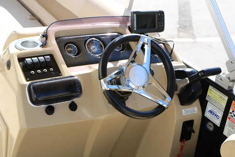 Slide: The Image of Steering console of 2020 Crest Classic Fish 200 boat with gauges and controls. - 26