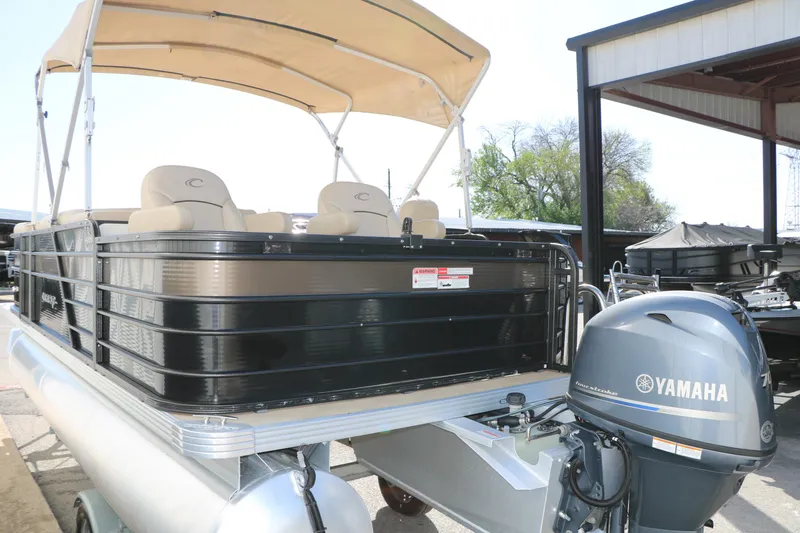 Slide: The Image of 2020 Crest Classic Fish 200 pontoon boat with Yamaha motor, beige canopy, and seating. - 6
