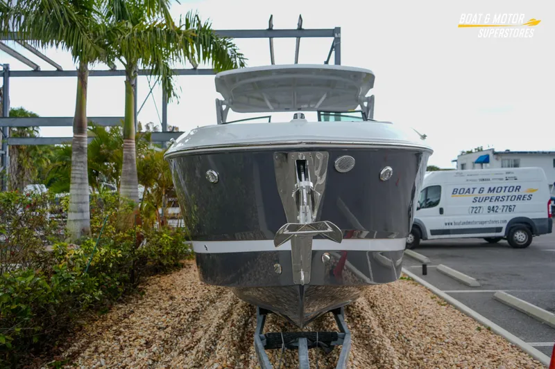 Slide: The Image of 2026 Four Winns H9 OB boat displayed at dealership with palm trees and service van. - 12