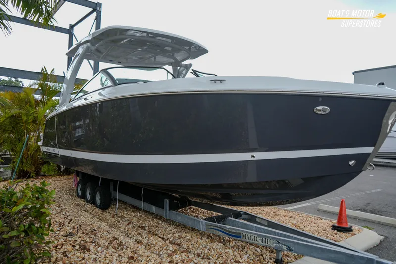 Slide: The Image of 2026 Four Winns H9 OB boat on trailer at dealership, side view. - 13