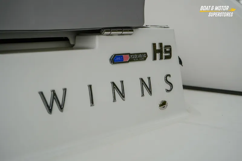 Slide: The Image of 2026 Four Winns H9 OB boat branding detail with logo and model name. - 21