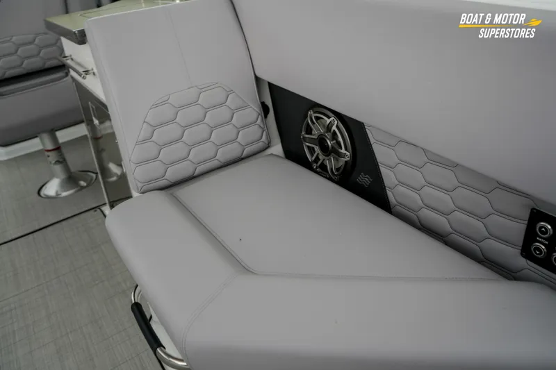 Slide: The Image of 2026 Four Winns H9 OB boat interior with hexagonal-patterned seating and integrated speaker system. - 28