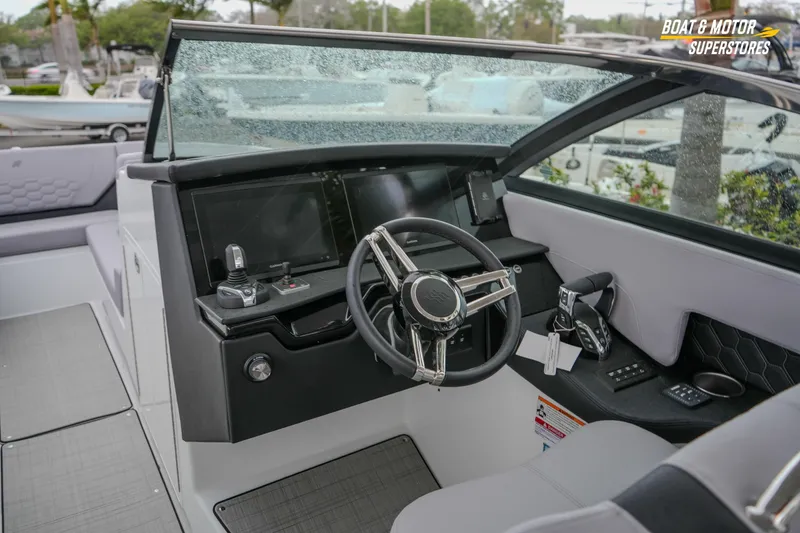 Slide: The Image of 2026 Four Winns H9 OB boat cockpit with modern steering and controls. - 33