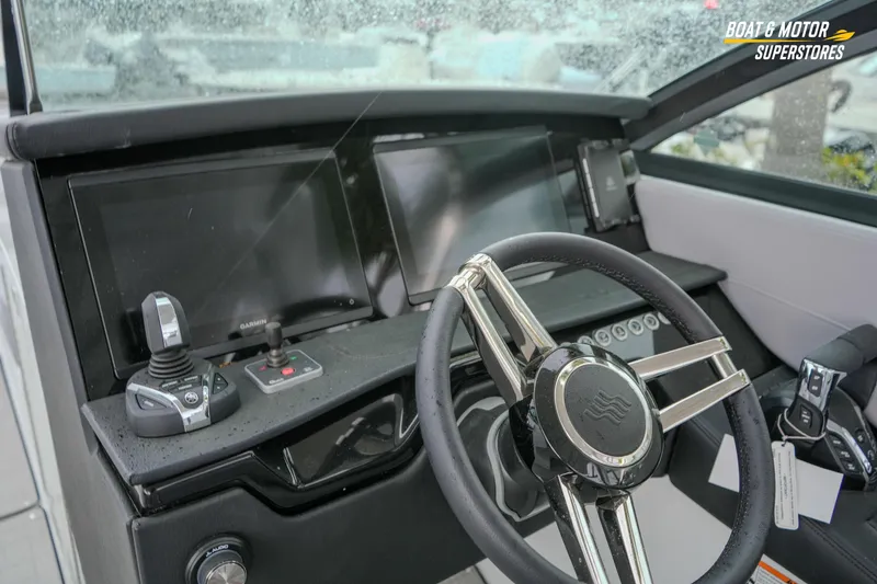 Slide: The Image of 2026 Four Winns H9 OB boat dashboard with modern controls and steering wheel. - 34