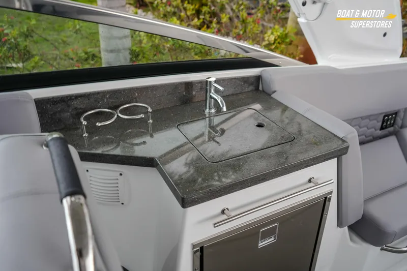 Slide: The Image of 2026 Four Winns H9 OB boat interior with sleek kitchenette and modern fixtures. - 41