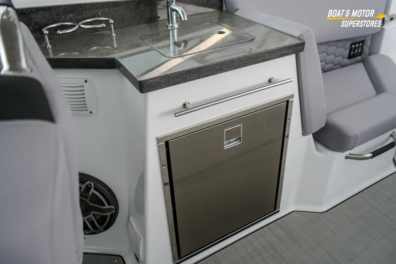 Slide: The Image of 2026 Four Winns H9 OB boat interior with kitchenette and seating area. - 42