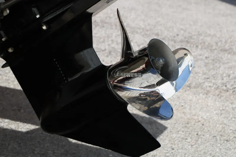Slide: The Image of Close-up of a 2002 Rinker 192 Captiva Bowrider boat propeller on concrete surface. - 10