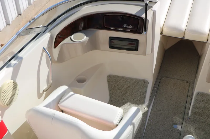 Slide: The Image of Interior of a 2002 Rinker 192 Captiva Bowrider boat, featuring seating and dashboard. - 19