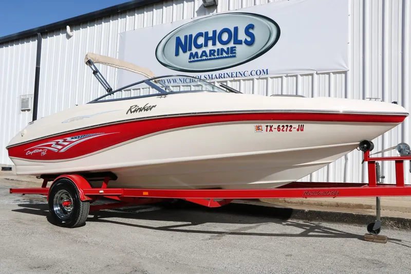 Slide: The Image of 2002 Rinker 192 Captiva Bowrider boat on red trailer at Nichols Marine. - 26