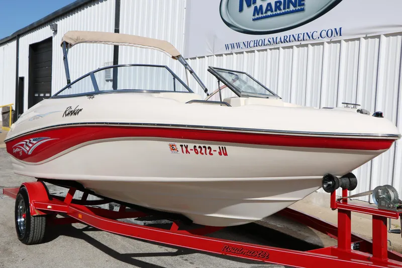 Slide: The Image of 2002 Rinker 192 Captiva Bowrider on red trailer outside Nichols Marine building. - 3