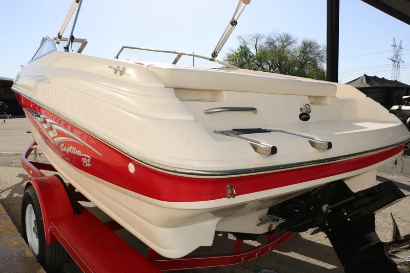 Slide: The Image of 2002 Rinker 192 Captiva Bowrider boat on trailer, rear view, red and white design. - 9