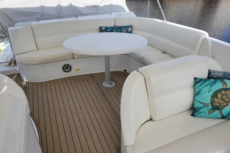 Slide: The Image of Luxurious seating area on 2001 Carver 570 Voyager Pilothouse yacht with decorative pillows. - 102