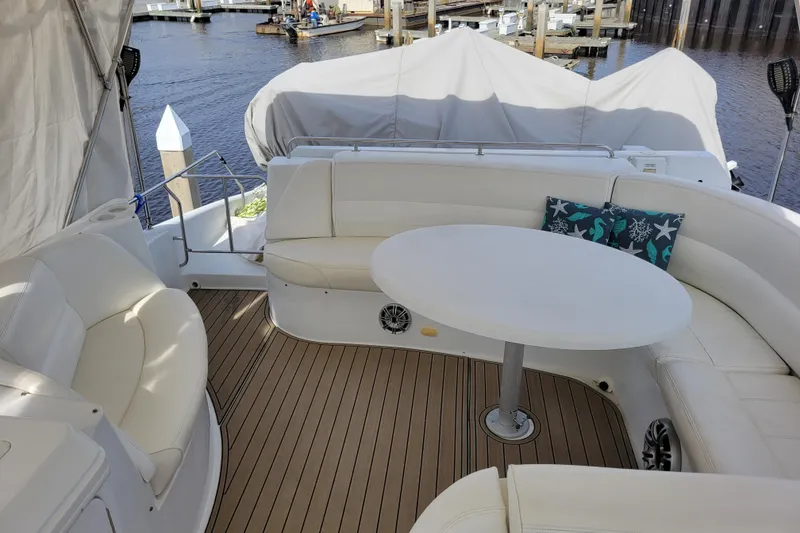 Slide: The Image of Luxurious 2001 Carver 570 Voyager Pilothouse yacht with elegant seating and table on deck. - 105