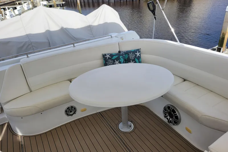Slide: The Image of Luxurious seating area on 2001 Carver 570 Voyager Pilothouse yacht with round table. - 106