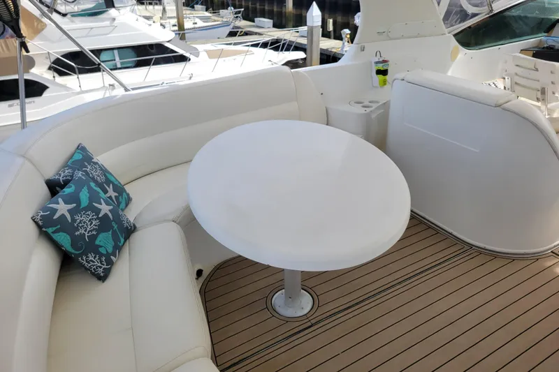 Slide: The Image of Luxurious seating area on 2001 Carver 570 Voyager Pilothouse yacht with round table and cushions. - 108