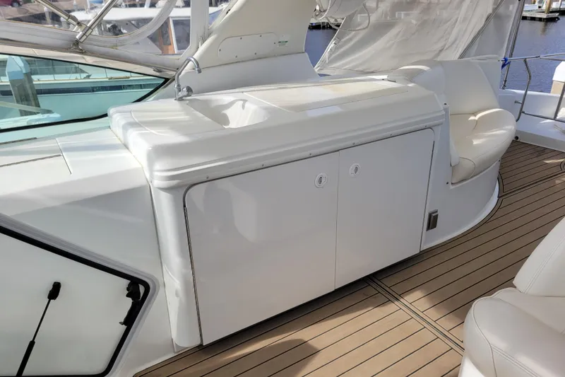 Slide: The Image of 2001 Carver 570 Voyager Pilothouse yacht with outdoor sink and seating area. - 113