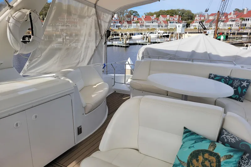Slide: The Image of Luxurious 2001 Carver 570 Voyager Pilothouse yacht interior with white seating and decorative pillows. - 114
