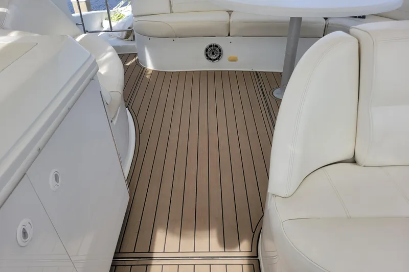 Slide: The Image of Luxurious interior of 2001 Carver 570 Voyager Pilothouse with white seating and wood flooring. - 117