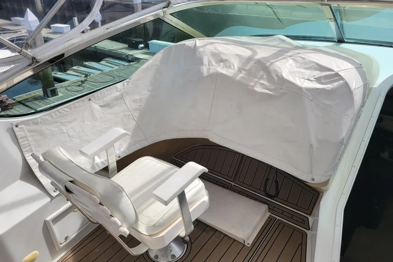Slide: The Image of Captain's chair on 2001 Carver 570 Voyager Pilothouse, covered helm, dockside view. - 118