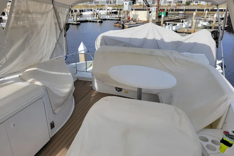 Slide: The Image of Covered seating area on a 2001 Carver 570 Voyager Pilothouse yacht at a marina. - 124