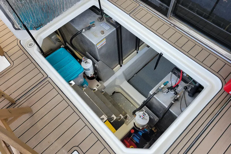 Slide: The Image of Engine compartment of a 2001 Carver 570 Voyager Pilothouse yacht, showcasing mechanical components. - 125