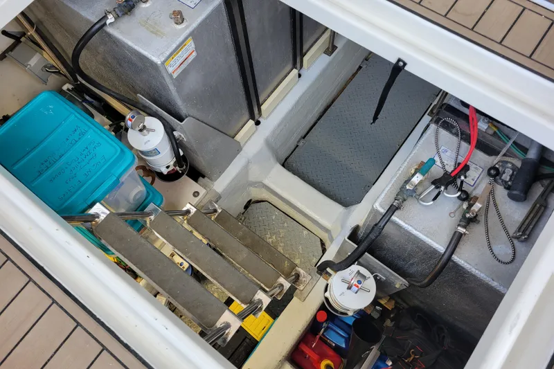 Slide: The Image of Engine compartment of a 2001 Carver 570 Voyager Pilothouse with visible equipment and storage. - 126