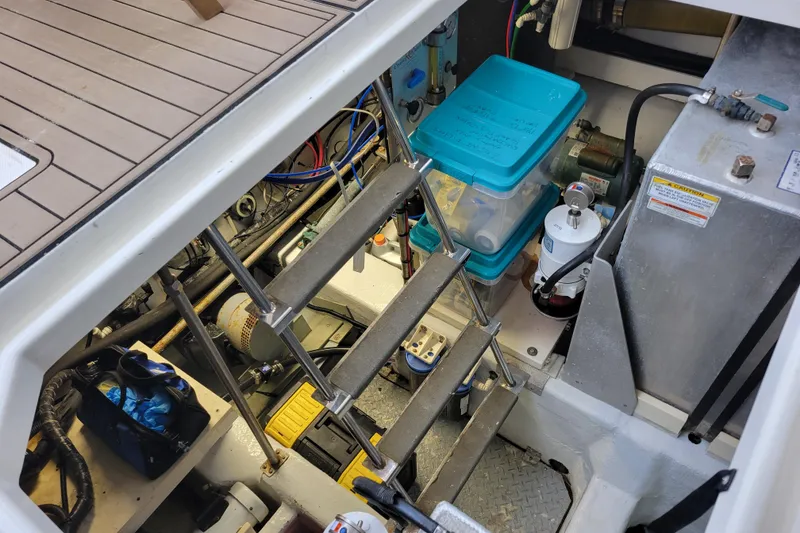 Slide: The Image of Engine room of 2001 Carver 570 Voyager Pilothouse with equipment and storage containers. - 127