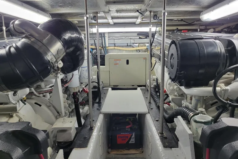 Slide: The Image of Engine room of a 2001 Carver 570 Voyager Pilothouse with visible machinery and components. - 129