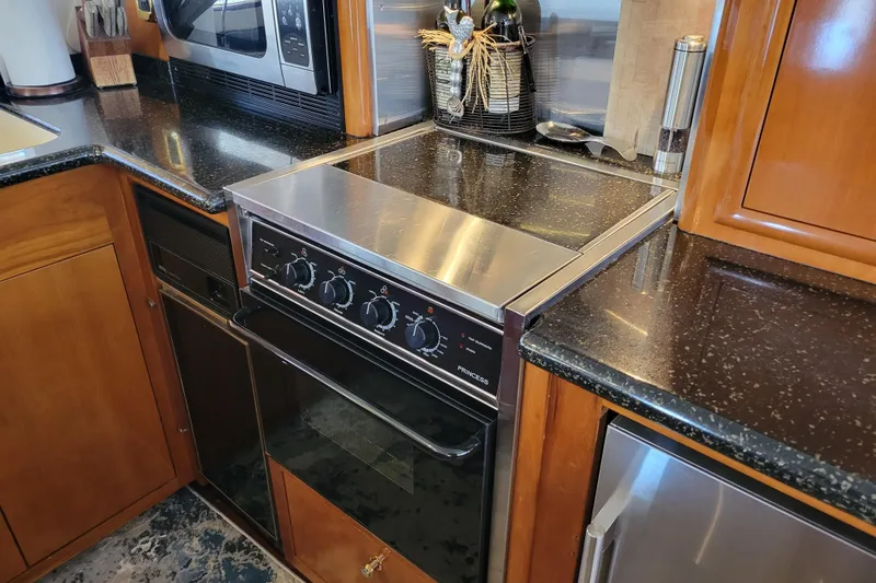 Slide: The Image of Galley kitchen in 2001 Carver 570 Voyager Pilothouse with stove and microwave. - 13