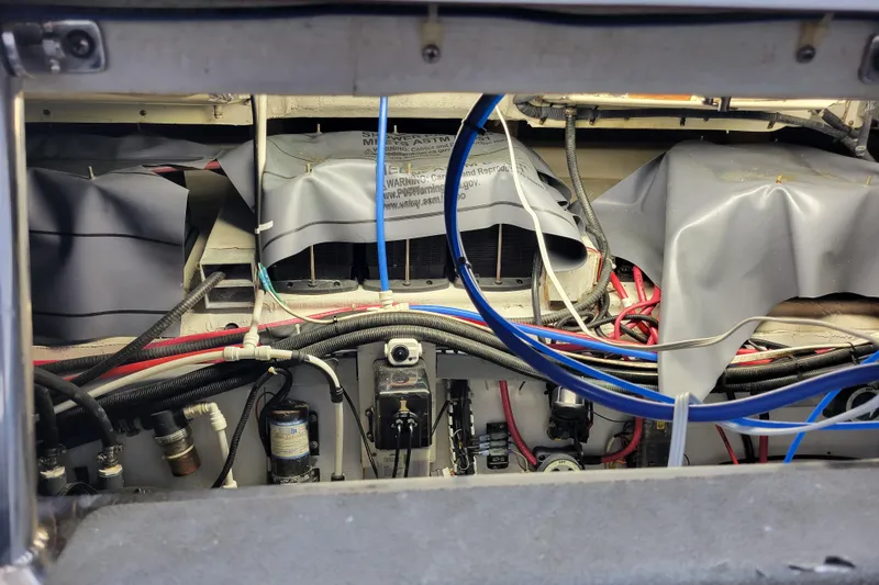 Slide: The Image of Engine compartment of a 2001 Carver 570 Voyager Pilothouse with visible wiring and components. - 132