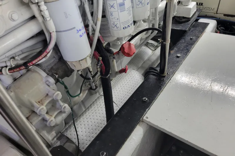 Slide: The Image of Engine room of a 2001 Carver 570 Voyager Pilothouse with visible filters and wiring. - 136