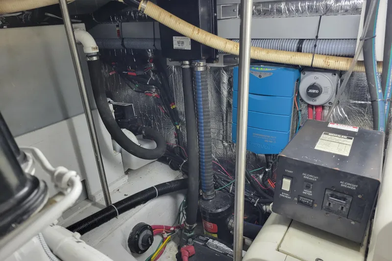 Slide: The Image of Engine room of a 2001 Carver 570 Voyager Pilothouse with electrical components and wiring. - 138