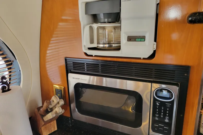 Slide: The Image of Interior of 2001 Carver 570 Voyager Pilothouse with coffee maker and microwave. - 14