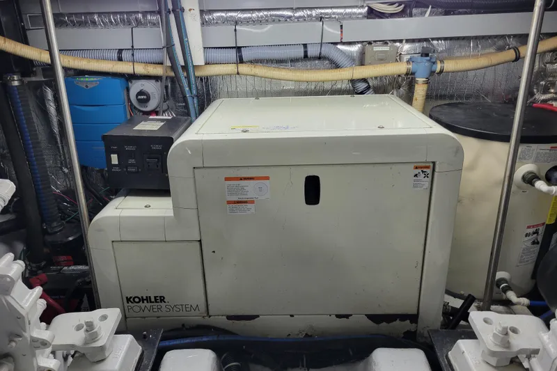 Slide: The Image of Engine room of 2001 Carver 570 Voyager Pilothouse with Kohler power system. - 140