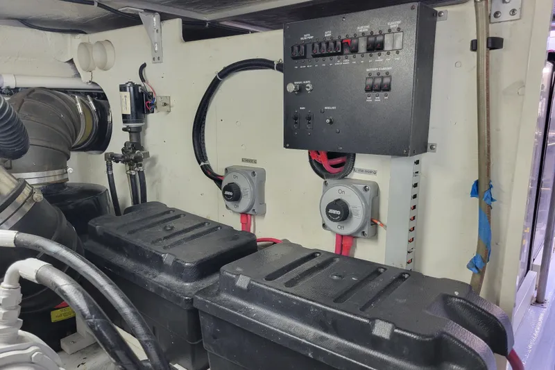 Slide: The Image of Engine room of 2001 Carver 570 Voyager Pilothouse with electrical panel and battery boxes. - 143