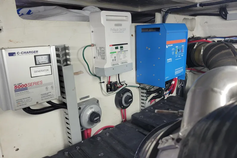 Slide: The Image of Electrical system components in a 2001 Carver 570 Voyager Pilothouse engine room. - 144
