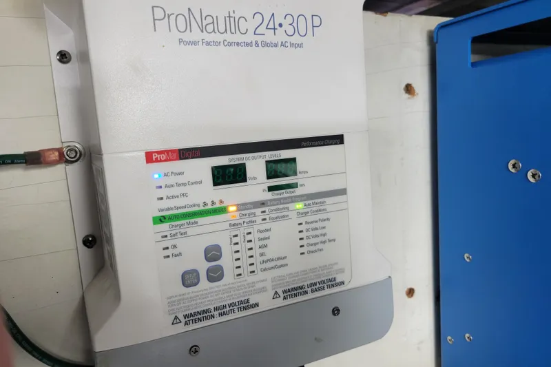 Slide: The Image of ProNautic 24-30P charger in 2001 Carver 570 Voyager Pilothouse, displaying system status. - 146