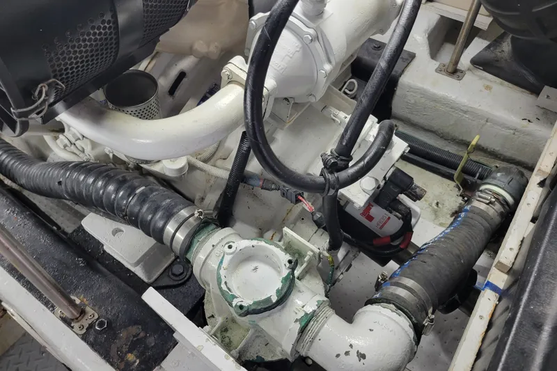 Slide: The Image of Engine compartment of a 2001 Carver 570 Voyager Pilothouse with visible hoses and components. - 148