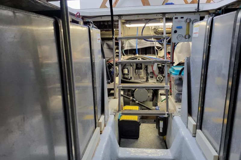 Slide: The Image of Engine room of 2001 Carver 570 Voyager Pilothouse with visible machinery and equipment. - 150