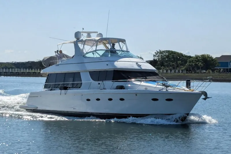 Slide: The Image of 2001 Carver 570 Voyager Pilothouse yacht cruising on a sunny day. - 163