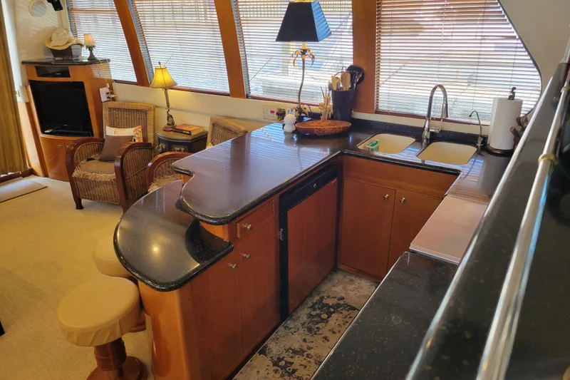 Slide: The Image of Luxurious 2001 Carver 570 Voyager Pilothouse interior with elegant kitchen and seating area. - 17